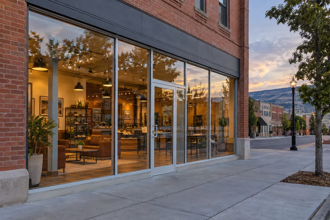 Brick main-street storefront with new full-height aluminum storefront glass and entry door